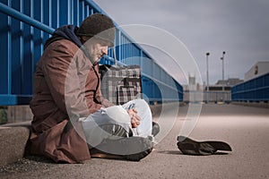 Pensioner in poor style of beggar asking on public for some pittance