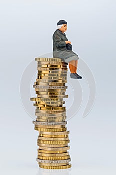 Pensioner sitting on money stack