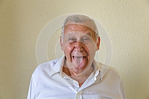 Pensioner sticking out his tongue