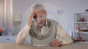 Pensioner trying to combine puzzle, having memory problems, cognitive impairment photo