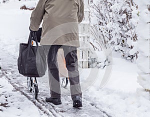 Pensioner in winter with a rollator