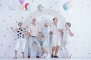 Pensioners dancing at party photo