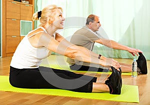 Pensioners doing exercises indoor