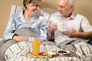 Pensioners drinking coffee in the bed