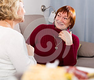 pensioners females talking on sofa