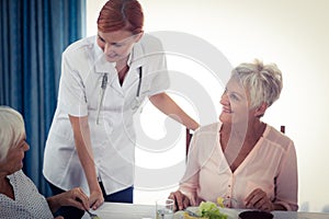 Pensioners at lunch with nurse