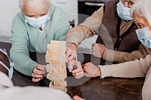 pensioners in medical masks playing tower