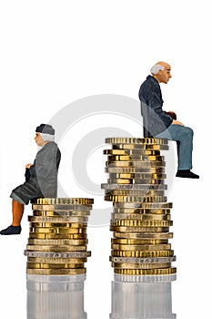 Pensioners and pensioner sitting on pile of money photo