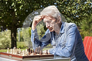 Pensioners playing chess photo