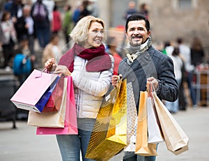 Pensioners with shopping bags on city street