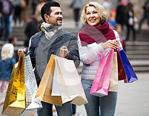 Pensioners with shopping bags on city street