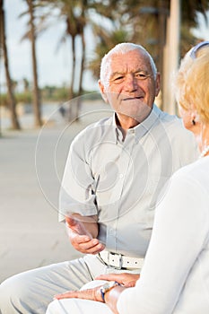 pensioners woman and man sitting and talking