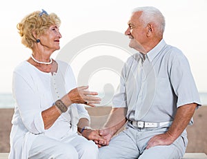 pensioners woman and man sitting and talking