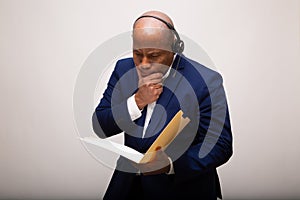 Pensive African American Businessman Looks Through File