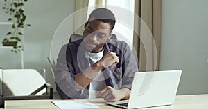 Pensive african american student guy ponders idea makes notes for future project book on on a sheet of paper studies