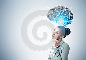 Pensive African American woman and brain hologram