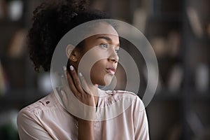 Pensive African American woman look in distance thinking