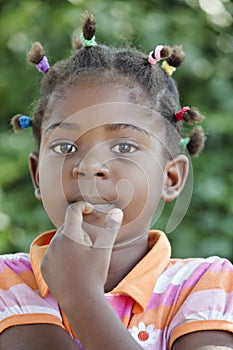 pensive african girl with several colorful ponytails
