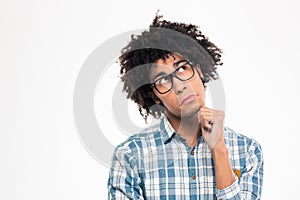 Pensive afro american man in glasses looking up