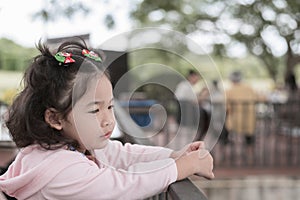 Pensive asian little girl thinking and looking away