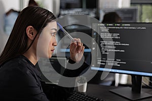 Pensive asian it programmer thinking at html script development
