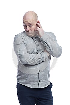 Pensive bald man Guy in a gray shirt. Problems and complex solutions. Isolated on a white background. Vertical