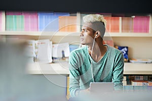 Pensive black student in library