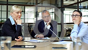 Pensive bored office employees sitting table, lack of ideas occupational burnout