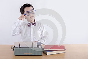 Pensive boy with typewriter