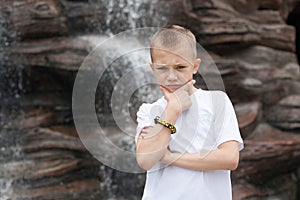 Pensive boy waterfall