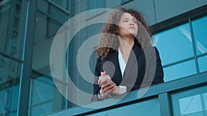 Pensive business girl lady on terrace balcony of office looking away thinking young businesswoman leader employer female