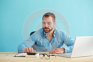 Pensive businessman calculates taxes