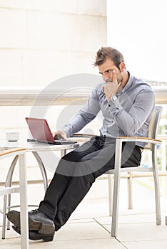 Pensive businessman laptop computer.