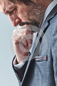 Pensive businessman overburdened with thoughts thinking with hand on chin