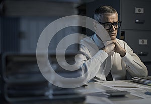 Pensive businessman overloaded with paperwork