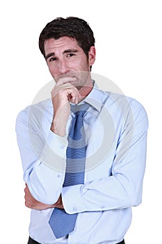 Pensive businessman rubbing chin