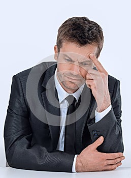 Pensive businessman sitting at the table