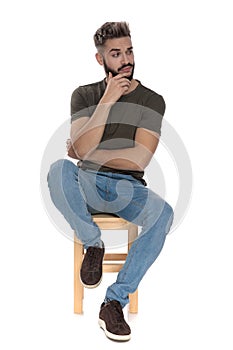 Pensive casual man looking away bothered photo