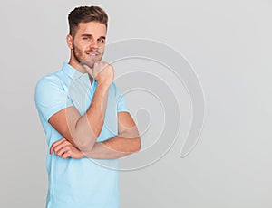 Pensive casual man wearing a polo shirt with short sleeves