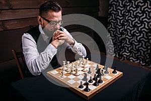 Pensive chess player thinking about game strategy