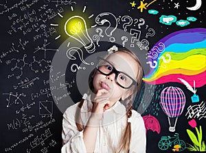 Pensive child school student with yellow lightbulb