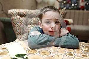 Pensive child at table in restaurant