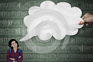 Pensive college student looking at cloud bubble