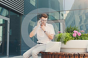 Pensive confident businessman working outdoors