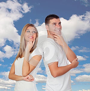 Pensive couple with a blue sky