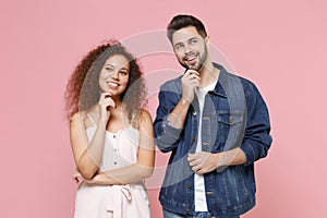 Pensive couple two friends european guy african american girl in casual clothes isolated on pastel pink background