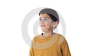 Pensive cute Spanish child with yellow t-shirt