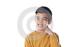 Pensive cute Spanish child with yellow t-shirt