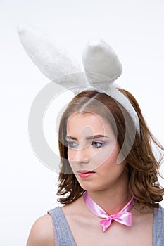 Pensive cute woman in rabbit ears looking away