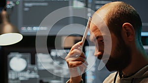 Pensive database admin brainstorming ideas in office